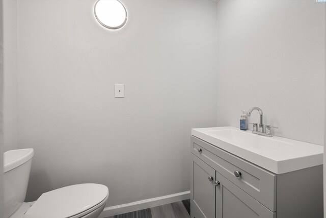 312 Mccabe St, Walla Walla, WA 99362 - half bath with toilet, vanity, wood finished floors, and baseboards