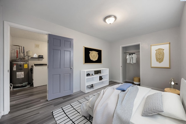 312 Mccabe St, Walla Walla, WA 99362 - bedroom with water heater, wood finished floors, a closet, baseboards, and washer / dryer