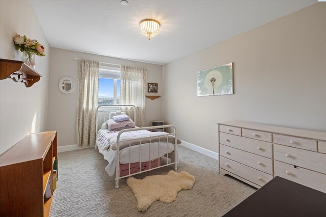 bedroom with light carpet and baseboards