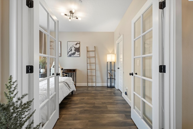 bedroom with baseboards, dark wood-type flooring, and french doors