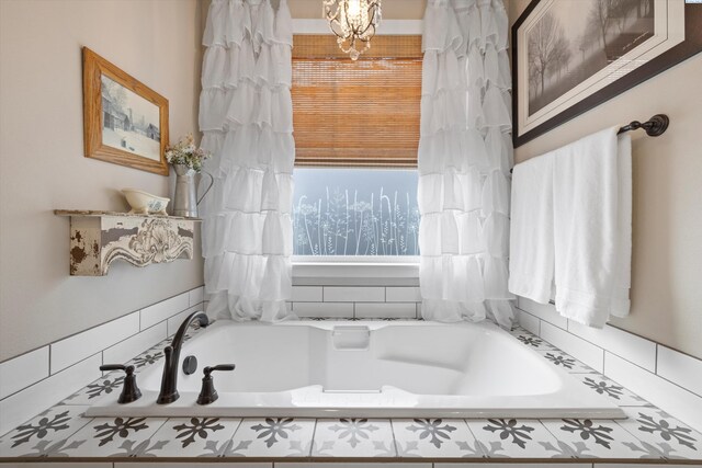 full bathroom featuring a chandelier and a garden tub