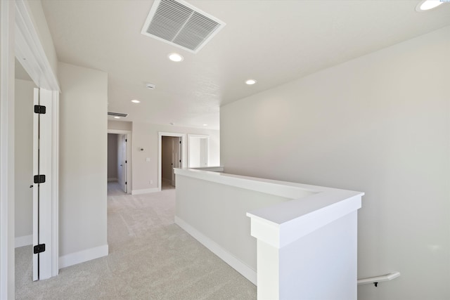 hallway with light colored carpet