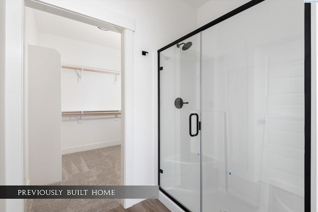 bathroom with a shower with door