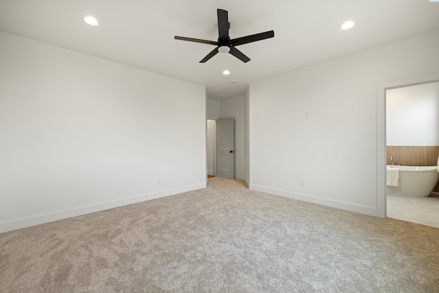 unfurnished bedroom featuring light carpet, ceiling fan, and ensuite bathroom