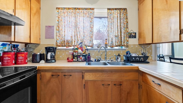 2113 Rainier Ave, Richland, WA 99354 - kitchen with tile countertops, ventilation hood, tasteful backsplash, and a sink