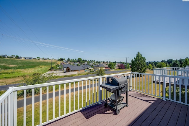 deck featuring grilling area and a lawn