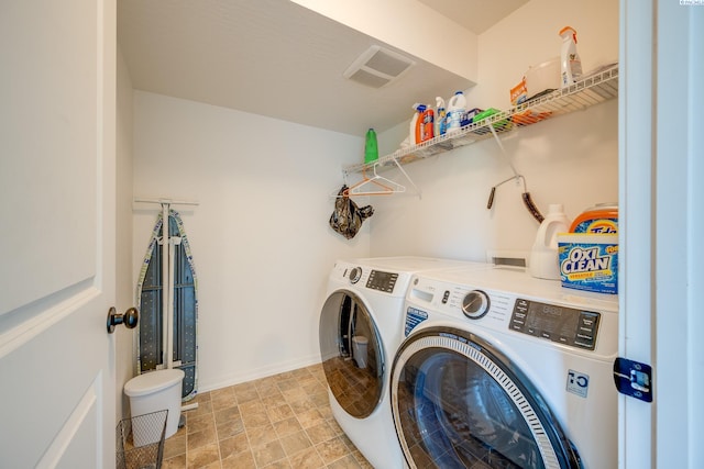 clothes washing area featuring independent washer and dryer