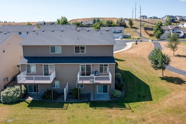 rear view of property with a yard