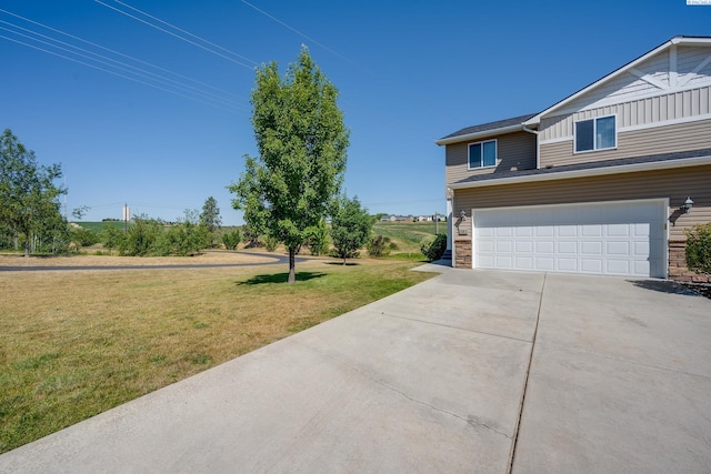 exterior space with a garage and a lawn