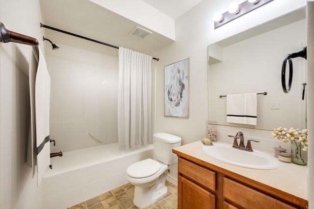 full bathroom with vanity, shower / tub combo, and toilet