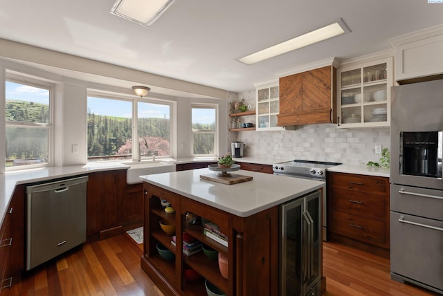 kitchen featuring a sink, open shelves, stainless steel appliances, light countertops, and wine cooler