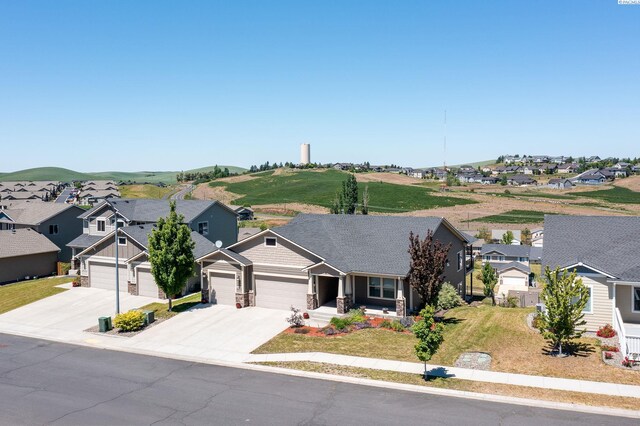 1390 SW Panorama Dr, Pullman, WA 99163 - craftsman-style house with a residential view, a garage, concrete driveway, and a front yard