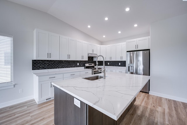 1390 SW Panorama Dr, Pullman, WA 99163 - kitchen with a sink, appliances with stainless steel finishes, lofted ceiling, tasteful backsplash, and white cabinets