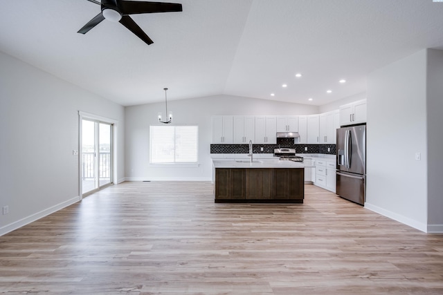 1390 SW Panorama Dr, Pullman, WA 99163 - kitchen with stainless steel appliances, a sink, lofted ceiling, light countertops, and under cabinet range hood