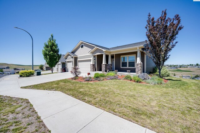 1390 SW Panorama Dr, Pullman, WA 99163 - craftsman-style house with a garage, a porch, driveway, a front yard, and stone siding