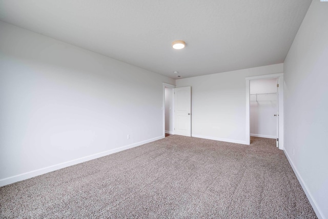 1390 SW Panorama Dr, Pullman, WA 99163 - unfurnished bedroom featuring carpet, baseboards, a walk in closet, and a closet