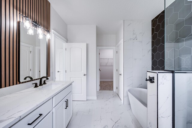 1390 SW Panorama Dr, Pullman, WA 99163 - bathroom with marble look tiles, a soaking tub, a walk in closet, and vanity