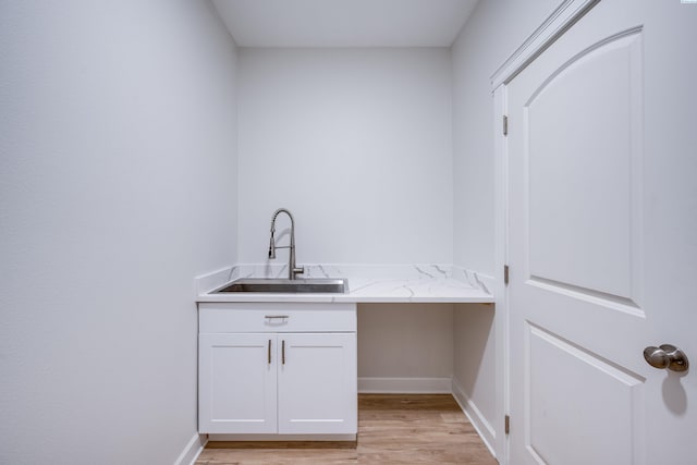 1390 SW Panorama Dr, Pullman, WA 99163 - laundry room featuring a sink, light wood-style flooring, and baseboards