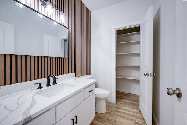 1390 SW Panorama Dr, Pullman, WA 99163 - bathroom with toilet, vanity, wood finished floors, and baseboards