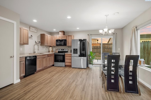 405 Whitefish Ln, Pasco, WA 99301 - kitchen featuring black appliances, a sink, a chandelier, light countertops, and light wood-style flooring