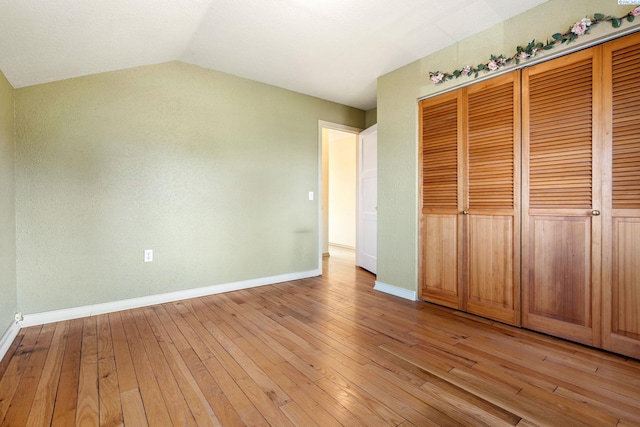 1515 Hains Ave, Richland, WA 99354 - unfurnished bedroom with a closet, vaulted ceiling, light wood-style flooring, and baseboards