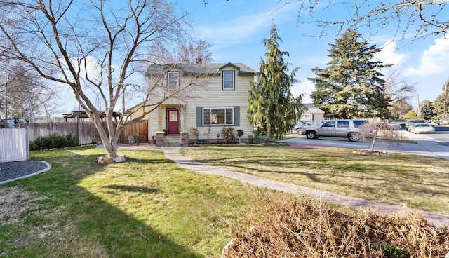 traditional-style home with a front yard and fence