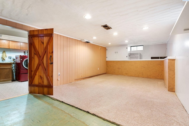 1515 Hains Ave, Richland, WA 99354 - basement featuring light colored carpet, wooden walls, visible vents, light floors, and washer / clothes dryer