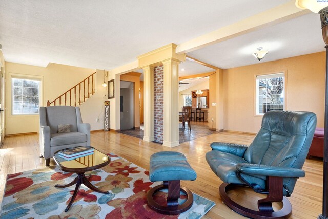 1515 Hains Ave, Richland, WA 99354 - living room featuring stairs, decorative columns, baseboards, and wood finished floors