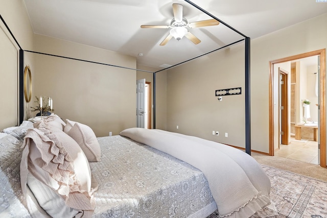 bedroom with carpet, baseboards, a ceiling fan, and ensuite bathroom