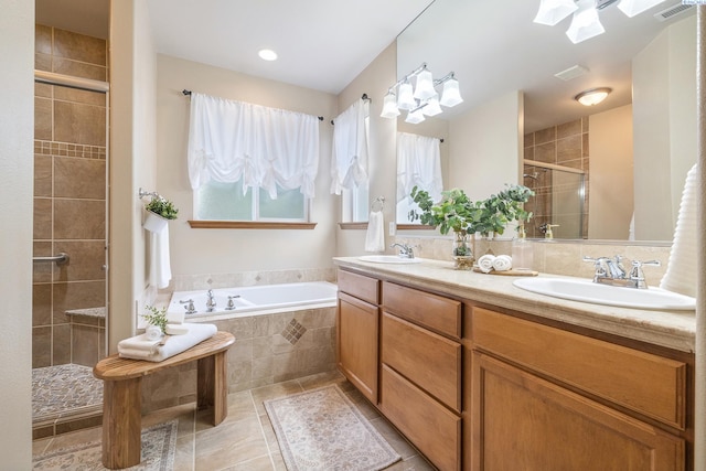 bathroom with a garden tub, double vanity, visible vents, a sink, and a shower stall