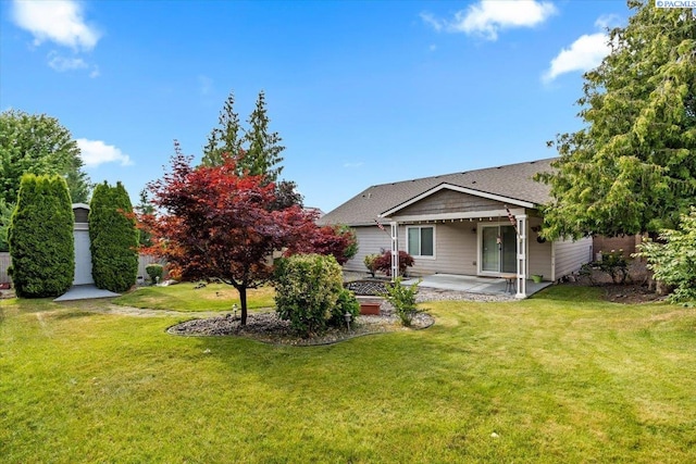 5709 W 23rd Ave, Kennewick, WA 99338 - rear view of house with a patio, a lawn, and roof with shingles