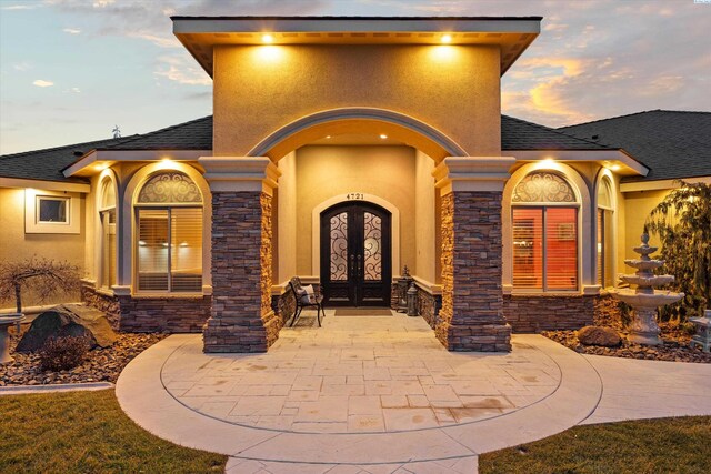 exterior entry at dusk with french doors