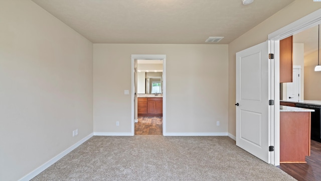 3245 S Palouse St, Kennewick, WA 99337 - unfurnished bedroom with baseboards, dark carpet, a sink, and ensuite bath
