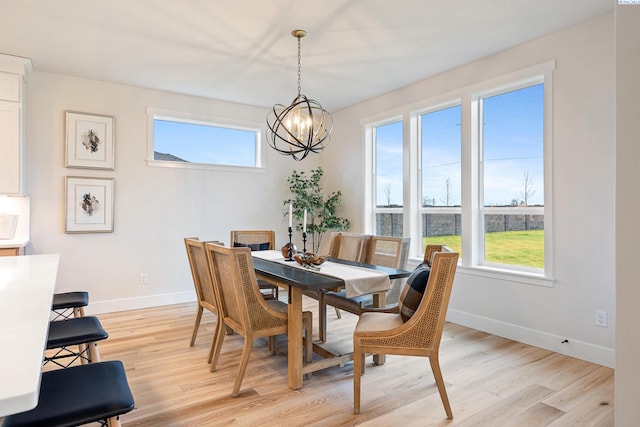 dining room featuring an inviting chandelier, light wood-type flooring, and a wealth of natural light