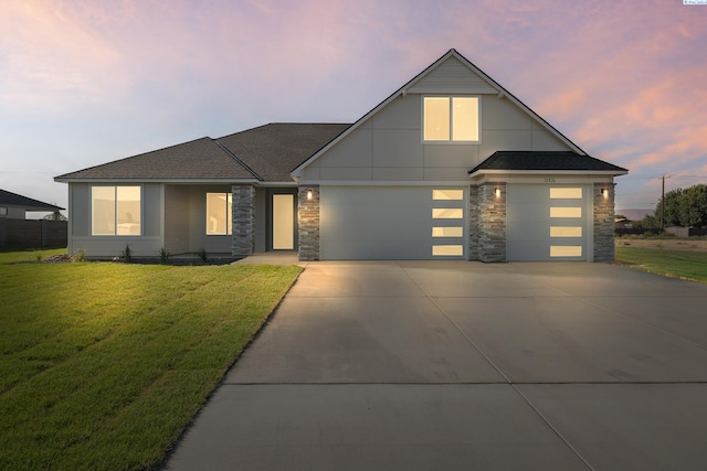 view of front facade with a garage and a yard