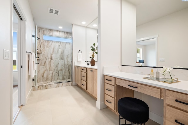 bathroom featuring vanity and an enclosed shower