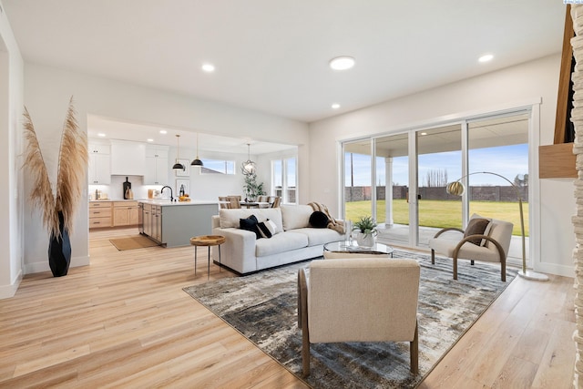 living room with sink and light hardwood / wood-style floors