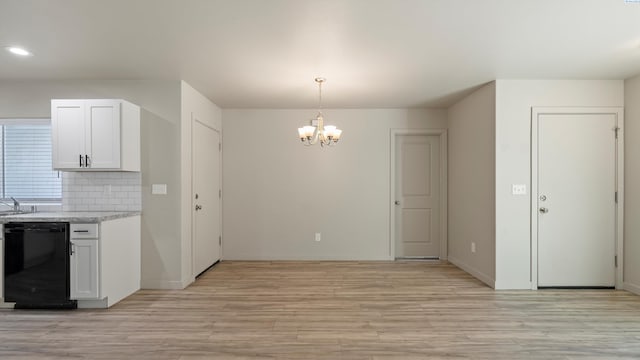 414 Whitefish Ln, Pasco, WA 99301 - kitchen with black dishwasher, a chandelier, light wood-style flooring, backsplash, and white cabinets
