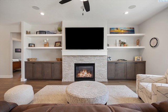 5770 W 40th Ave, Kennewick, WA 99338 - living area with ceiling fan, light wood finished floors, a stone fireplace, and built in shelves