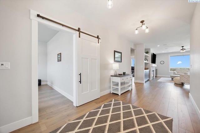 5770 W 40th Ave, Kennewick, WA 99338 - corridor with a barn door and wood-type flooring