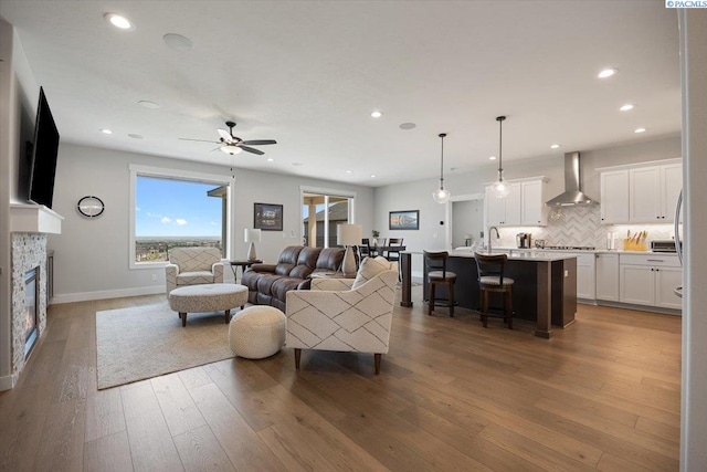 5770 W 40th Ave, Kennewick, WA 99338 - living room featuring ceiling fan, hardwood / wood-style flooring, a glass covered fireplace, and recessed lighting
