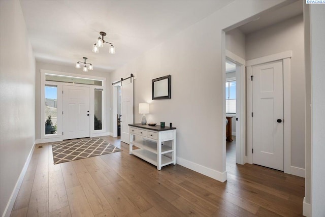 5770 W 40th Ave, Kennewick, WA 99338 - foyer with a barn door, hardwood / wood-style flooring, plenty of natural light, and a chandelier