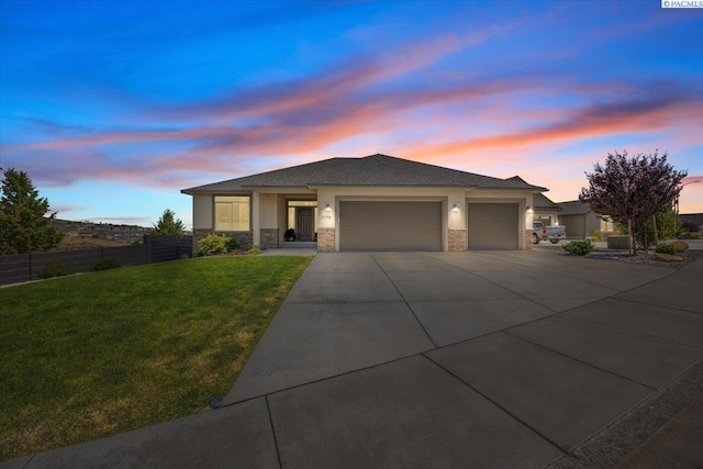 5770 W 40th Ave, Kennewick, WA 99338 - prairie-style house featuring a garage, stucco siding, concrete driveway, and stone siding
