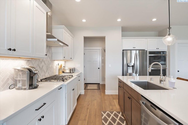 5770 W 40th Ave, Kennewick, WA 99338 - kitchen with appliances with stainless steel finishes, wall chimney range hood, light countertops, decorative backsplash, and recessed lighting