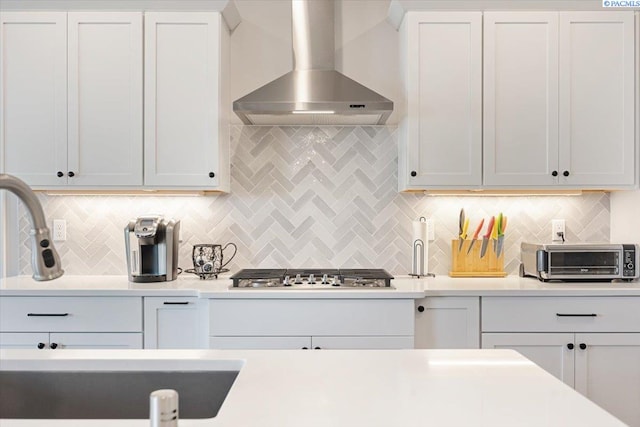 5770 W 40th Ave, Kennewick, WA 99338 - kitchen featuring wall chimney exhaust hood, stainless steel gas stovetop, light countertops, and backsplash