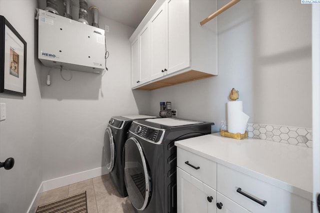 5770 W 40th Ave, Kennewick, WA 99338 - laundry room featuring cabinet space, washer and dryer, light tile patterned floors, and water heater