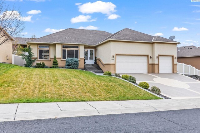 view of front of home featuring french doors, stucco siding, fence, an attached garage, and a front lawn