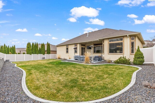 back of property with a patio, a fenced backyard, a lawn, roof with shingles, and stucco siding