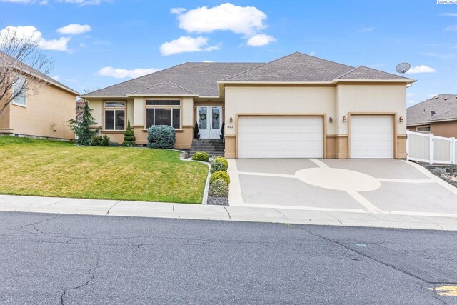 view of front of home with fence, an attached garage, a front yard, stucco siding, and french doors