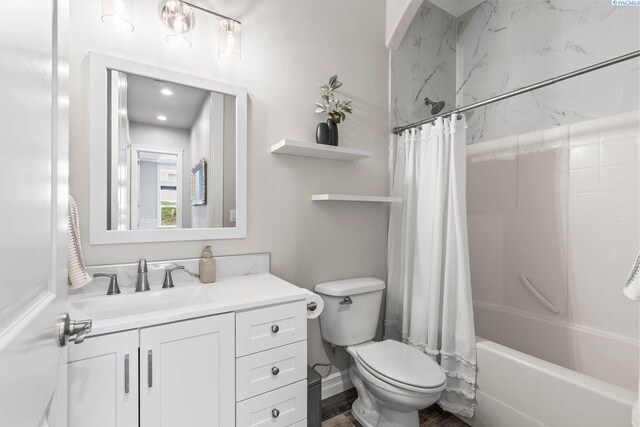 full bath with baseboards, toilet, shower / tub combo, and vanity